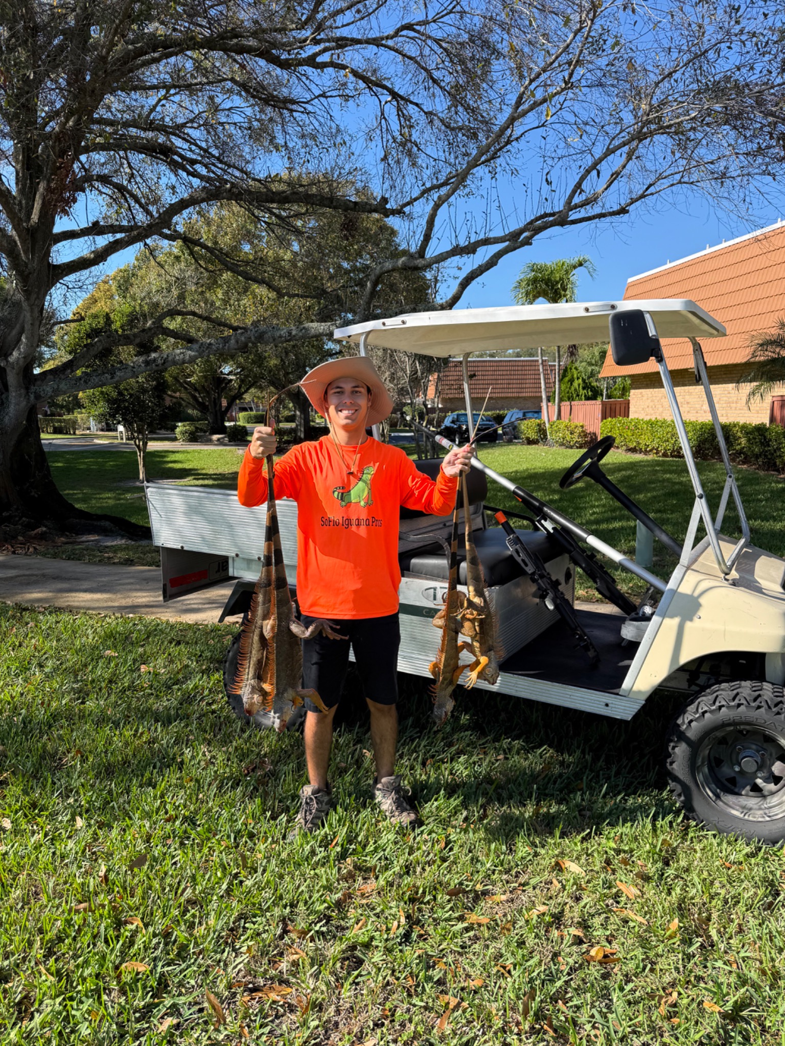 Technician holding iguanas during HOA community iguana removal service